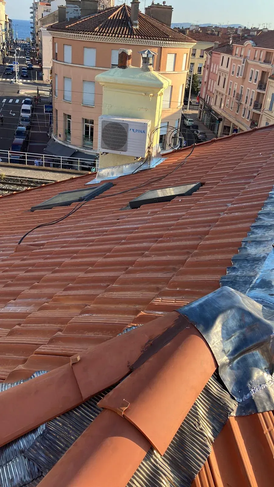 Travaux de zinguerie en zinc sur une toiture en ville littorale